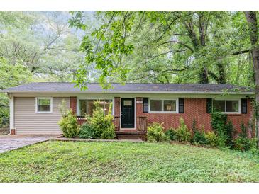 Charming one-story home featuring a classic brick facade and lovely landscaping at 205 E Cleveland Ave, Bessemer City, NC 28016