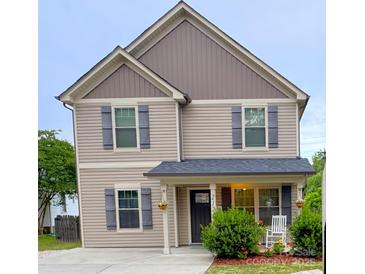Charming two-story home featuring neutral siding, gray shutters and a cozy front porch at 212 Old Centergrove Rd, Kannapolis, NC 28083