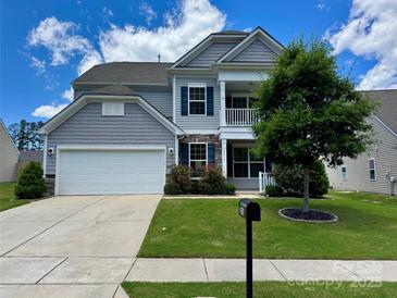 Charming two-story home featuring a two-car garage, well-maintained lawn, and an inviting front porch at 2311 Verde Creek Rd, Charlotte, NC 28214