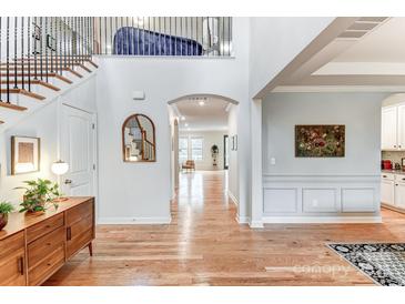 Welcoming foyer with hardwood floors, staircase, and views into the dining and living areas at 319 S San Agustin Dr, Mooresville, NC 28117