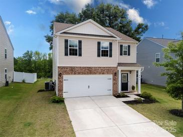 Two-story home with brick accents, a two-car garage, and a well-manicured front yard at 461 Misty Law Ln, Clover, SC 29710