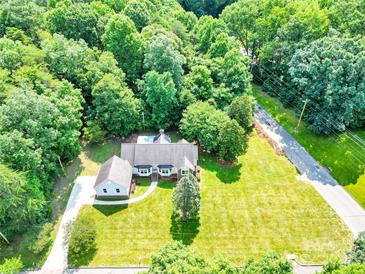 Stunning aerial view of home with lush greenery and swimming pool in the backyard at 511 Brookwood Dr, Statesville, NC 28677
