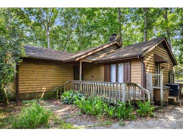 Rustic exterior of a cozy home with wooden siding and a quaint front porch at 8007 Red Lantern Rd, Indian Trail, NC 28079