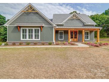 Charming home boasts attractive wood details, manicured landscaping, and a welcoming entrance at 0000 Trull Hinson Rd # 2, Wingate, NC 28174
