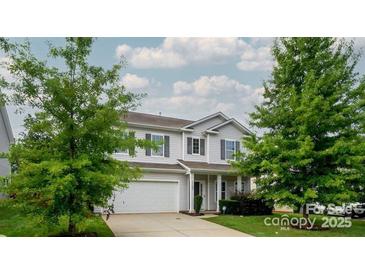 Charming two-story home with attached garage and well-maintained landscaping, set against a bright, cloudy sky at 11109 Pond Valley Ct, Charlotte, NC 28269