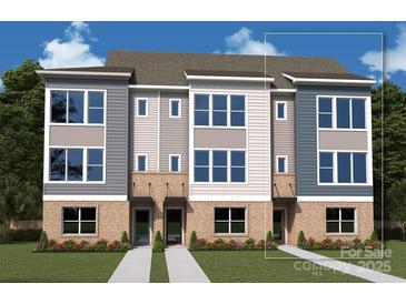 New construction townhome featuring brick accents, gray siding, and expansive windows at 1120 Bismuth Ave, Charlotte, NC 28211