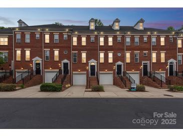 Charming brick townhomes with individual garages, front stairs, and well-maintained landscaping create inviting curb appeal at 1126 Dean Hall Ln, Matthews, NC 28105