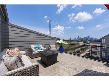 Relaxing rooftop deck featuring comfortable seating and stunning city views at 2108 Bryant Park Dr, Charlotte, NC 28208