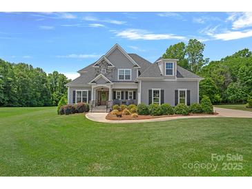 Charming two-story home with manicured lawn, decorative landscaping, and a welcoming entryway at 224 Hidden Meadows Dr, Mooresville, NC 28117