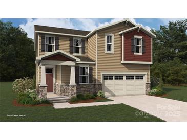Charming two-story home with stone accents, neutral siding, and an attached two-car garage at 2648 Tillman St, Monroe, NC 28112