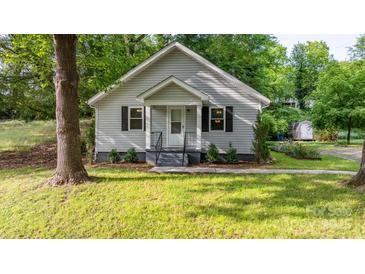 Charming gray home with a gabled roof, dark shutters, and a well-manicured lawn at 352 18Th Ne Ave, Hickory, NC 28601