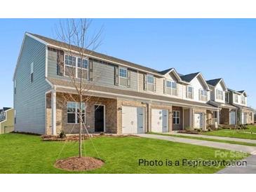 Street view of townhomes with brick facade, attached garages, and well-maintained lawns at 502 Mt. Mitchell Ave # 502, Gastonia, NC 28052