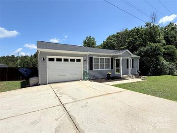 Charming single-story home with attached garage, manicured lawn, and inviting curb appeal at 5323 Flat Creek Rd, Heath Springs, SC 29058