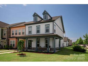 Charming two-story home featuring a welcoming front porch and well-manicured lawn at 1036 Riverwalk Pkwy, Rock Hill, SC 29730