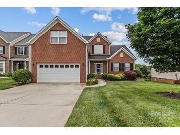 Charming two-story brick home with an attached garage and well-manicured lawn at 108 Planters Dr, Statesville, NC 28677