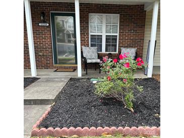 Inviting brick front porch with charming seating area and well-maintained landscaping at 11218 Grass Field Rd # 1083, Charlotte, NC 28213