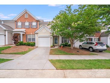 Charming townhouse with a well-manicured lawn, a driveway, and a one car garage at 11714 Harsworth Ln, Charlotte, NC 28277