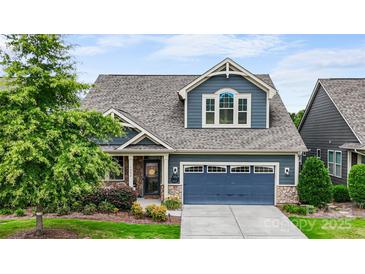 Charming two-story home boasts a blue exterior, well-manicured landscaping, and a two-car garage at 1284 Independence St, Fort Mill, SC 29708