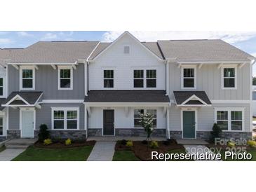 Charming townhomes feature modern farmhouse design with stone accents and inviting entryways at 205 Cliffwood Nw St # A-1, Concord, NC 28027