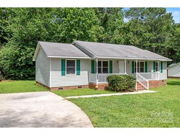 Charming ranch-style home featuring a well-maintained lawn, classic siding, and a welcoming front porch at 2223 Pacer Rd, Lancaster, SC 29720