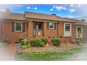 Charming brick home featuring well-maintained landscaping, a welcoming front entrance, and lovely curb appeal at 402 Swaim Ct, Salisbury, NC 28147