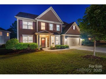 Charming two-story home boasts manicured landscaping and a welcoming stone facade at 4500 Carrington Dr, Lancaster, SC 29720