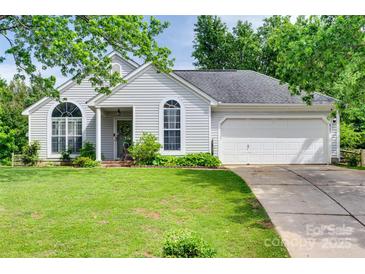 Charming single-story home with well-manicured lawn and attached garage on a sunny day at 4712 Avalon Forest Ln, Charlotte, NC 28269