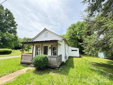 Charming single-story home with a covered porch and a well-maintained front yard at 502 E Main St, Cleveland, NC 27013
