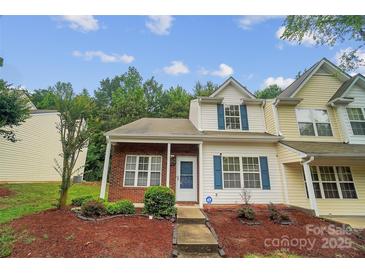 Charming townhouse with brick accents, blue shutters, and a well-maintained front yard landscape at 5237 Ficus Tree Ln, Charlotte, NC 28215