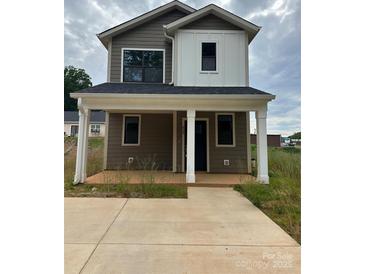 Charming two-story home with a covered front porch and a modern color scheme at 804 3Rd Street Sw Pl, Hickory, NC 28602