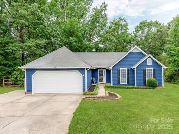 Charming blue single-story home featuring a two-car garage and a well-manicured lawn at 10736 Spruce Mountain Rd, Charlotte, NC 28214