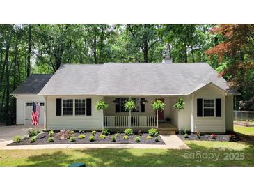 Charming single-story home with a welcoming porch and a well-manicured front yard at 109 Pepper Cir, Mooresville, NC 28117
