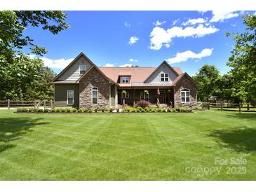 Charming exterior showcasing stone accents, manicured lawn, and inviting front porch at 114 Wingard Rd, Concord, NC 28025