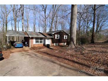 Charming brick home featuring a carport, mature trees, and a classic design in a quiet neighborhood at 170 Heritage Ln, Salisbury, NC 28147