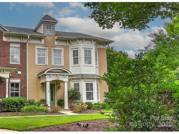 Charming home boasts a mix of brick and stucco, complemented by lush greenery and a well-manicured lawn at 17210 Sulky Plough Rd # 1206, Charlotte, NC 28277