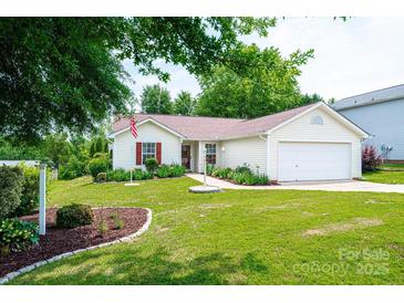 Charming single-story home featuring a well-manicured lawn and attached two car garage at 1957 8Th Street Se Ln, Hickory, NC 28602