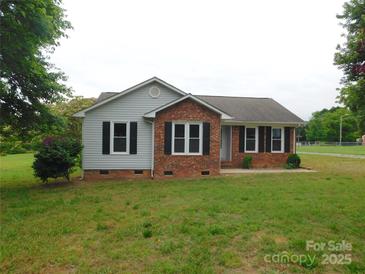 Charming home featuring a brick facade, black shutters, and a well-maintained lawn at 3001 Austin Chaney Rd, Monroe, NC 28110