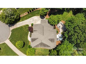 An aerial view of a well-maintained home with a backyard patio and lush greenery surrounding the property at 3009 Botetourt Ct, Weddington, NC 28104