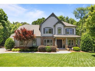 Charming two-story home with stone accents, manicured lawn, and a beautiful red maple tree at 3009 Botetourt Ct, Weddington, NC 28104