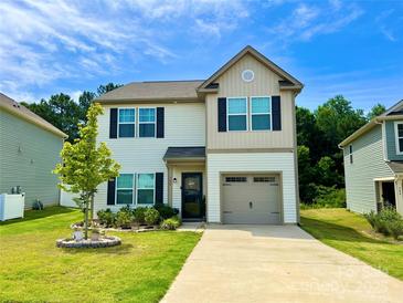 Charming two-story home with black shutters, a well-maintained lawn, and a beautiful front yard tree at 750 Fraternity Row, Kannapolis, NC 28081