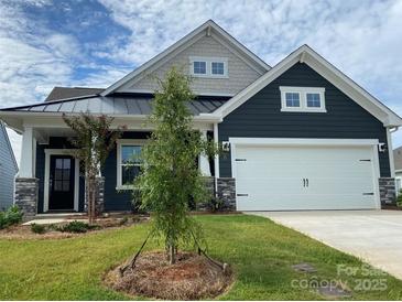 Charming new construction home featuring dark siding, stone accents, and a convenient two-car garage at 108 Red Juniper Way, Statesville, NC 28625