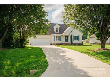 Charming single-Gathering home featuring a manicured lawn, long driveway, and attached two-car garage at 1083 Elljoy Ln, Salisbury, NC 28146