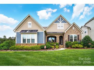 Charming two-story home with a beautifully landscaped yard and stone and siding facade at 10903 Skymont Dr, Huntersville, NC 28078