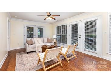 Bright living room with hardwood floors, ceiling fan, neutral colored walls, and natural light at 1136 W 1St St, Charlotte, NC 28202