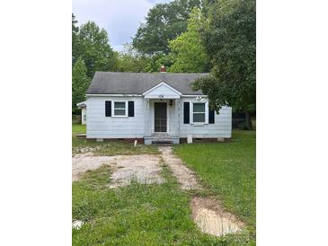 Exterior view of a one-story home with a gravel driveway and black shutters at 134 S Jackson Rd, Lancaster, SC 29720
