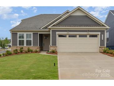 Charming single-Gathering home with a manicured lawn, neutral siding, and an attached two car garage at 1818 Winding Mist Dr, Belmont, NC 28012