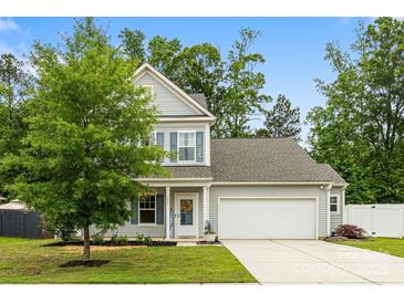Charming two-story home with gray siding, a well-manicured lawn, and a two-car garage at 3053 Riker St, Clover, SC 29710