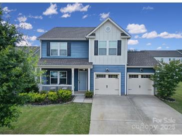 Charming two-story home featuring a covered porch, well-maintained lawn, and a convenient two-car garage at 5125 Thomasville Dr, Belmont, NC 28012