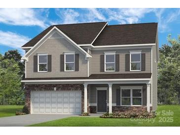 Charming two-story home featuring a two-car garage and classic architectural details at 5655 Arnold Way, Mount Pleasant, NC 28025