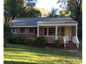 Charming single-story brick home with a covered front porch and well-maintained lawn at 632 Fortune St, Charlotte, NC 28205